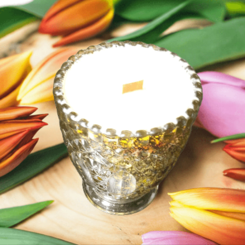 Decorative glass vase with textured surface on a bed of colorful tulips