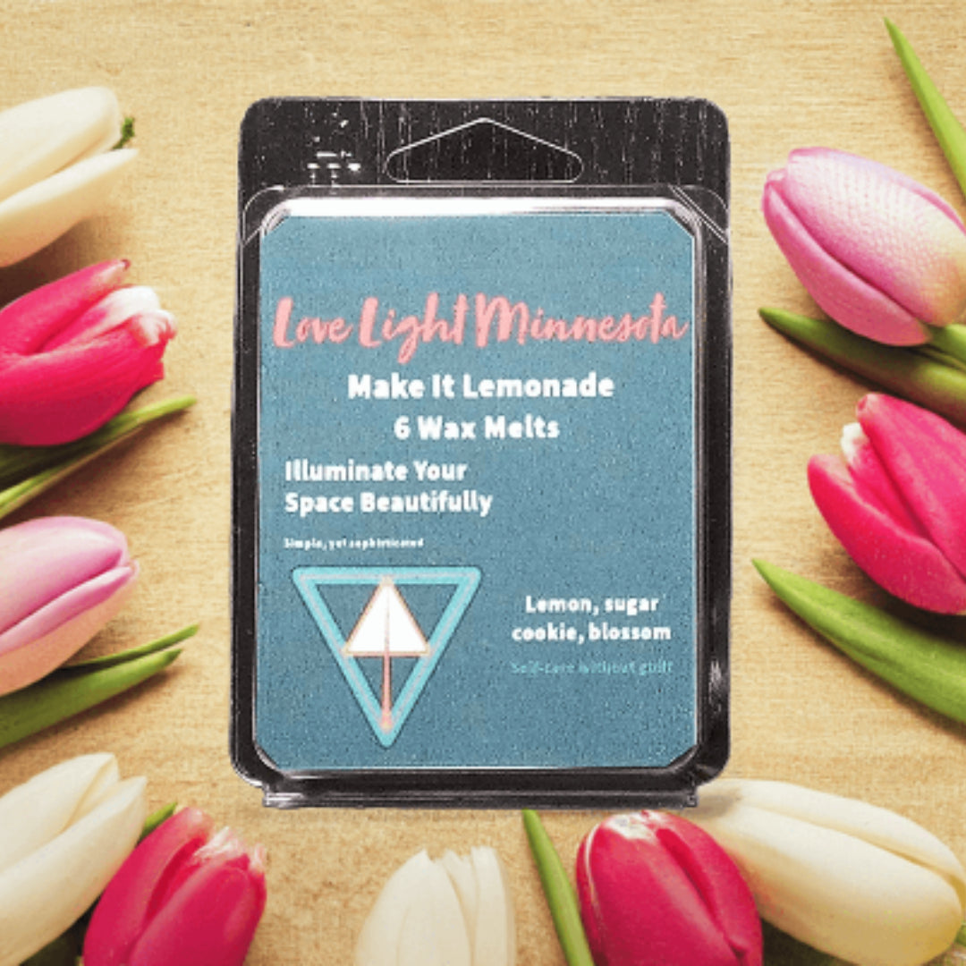 Pack of wax melts with a decorative background of pink and white tulips