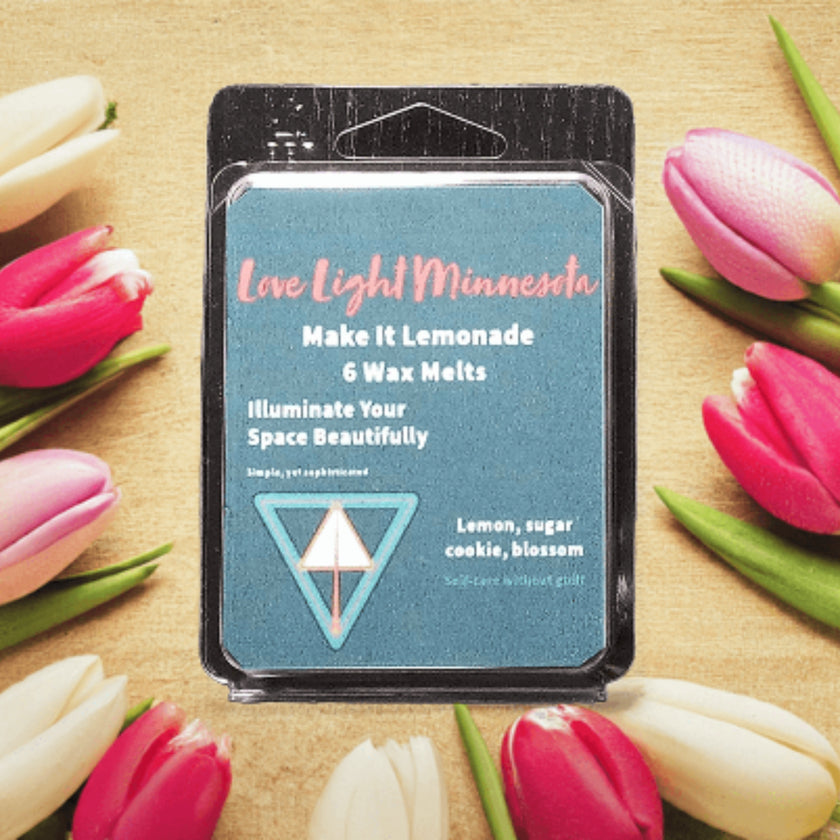 Pack of wax melts with a decorative background of pink and white tulips