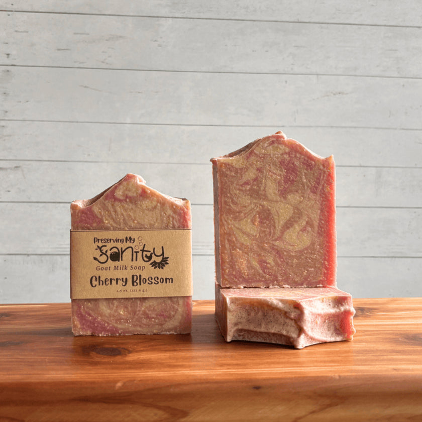 Two bars of cherry blossom soap with a 'Preserving My Sanity' label on a wooden surface.
