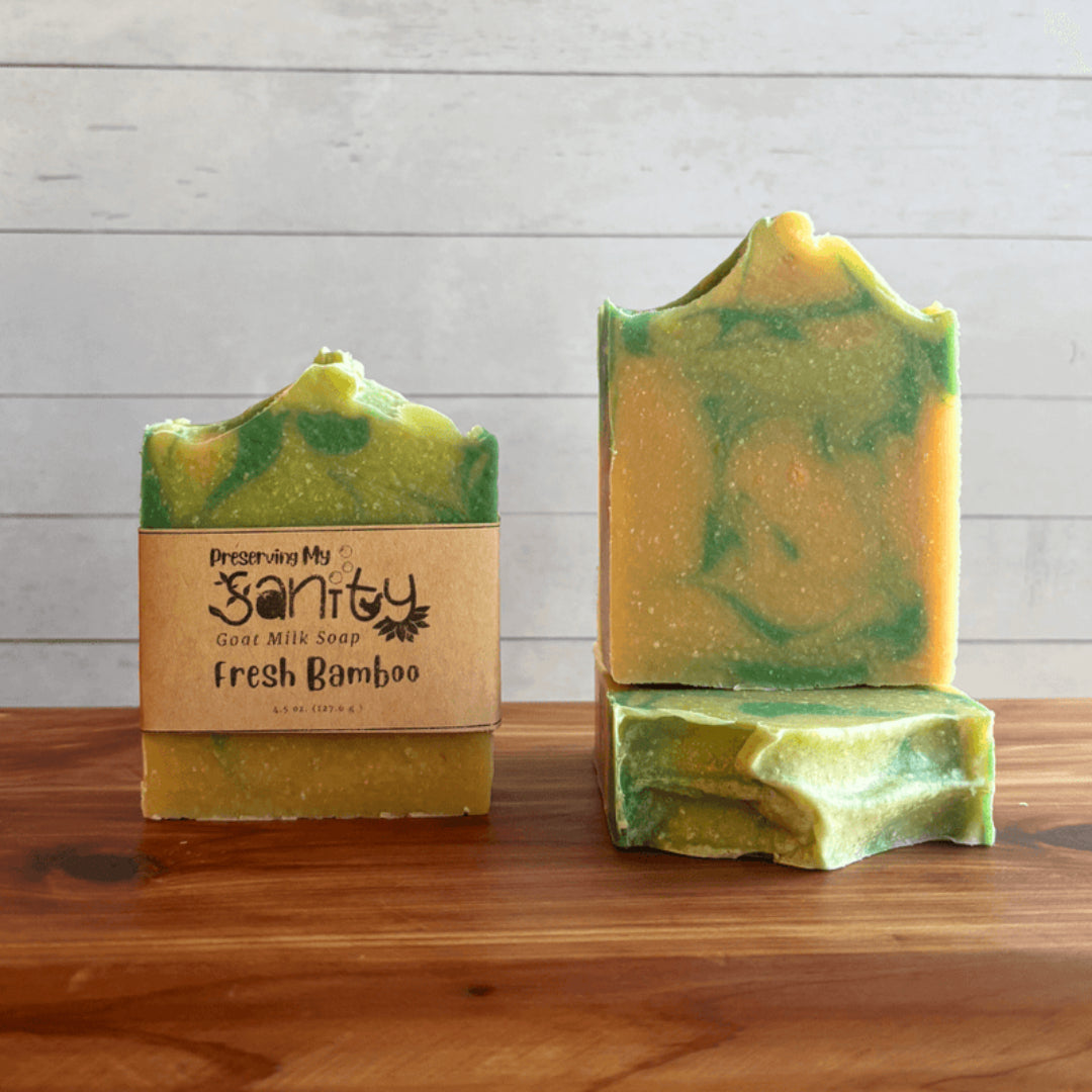 Two bars of green soap labeled Fresh Bamboo are displayed on a wooden surface.